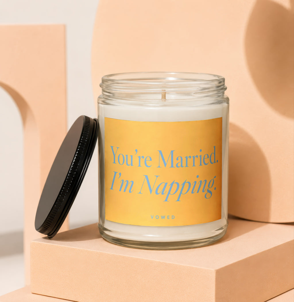 Scented candle with yellow label that reads "You're Married. I'm Napping." VOWED.