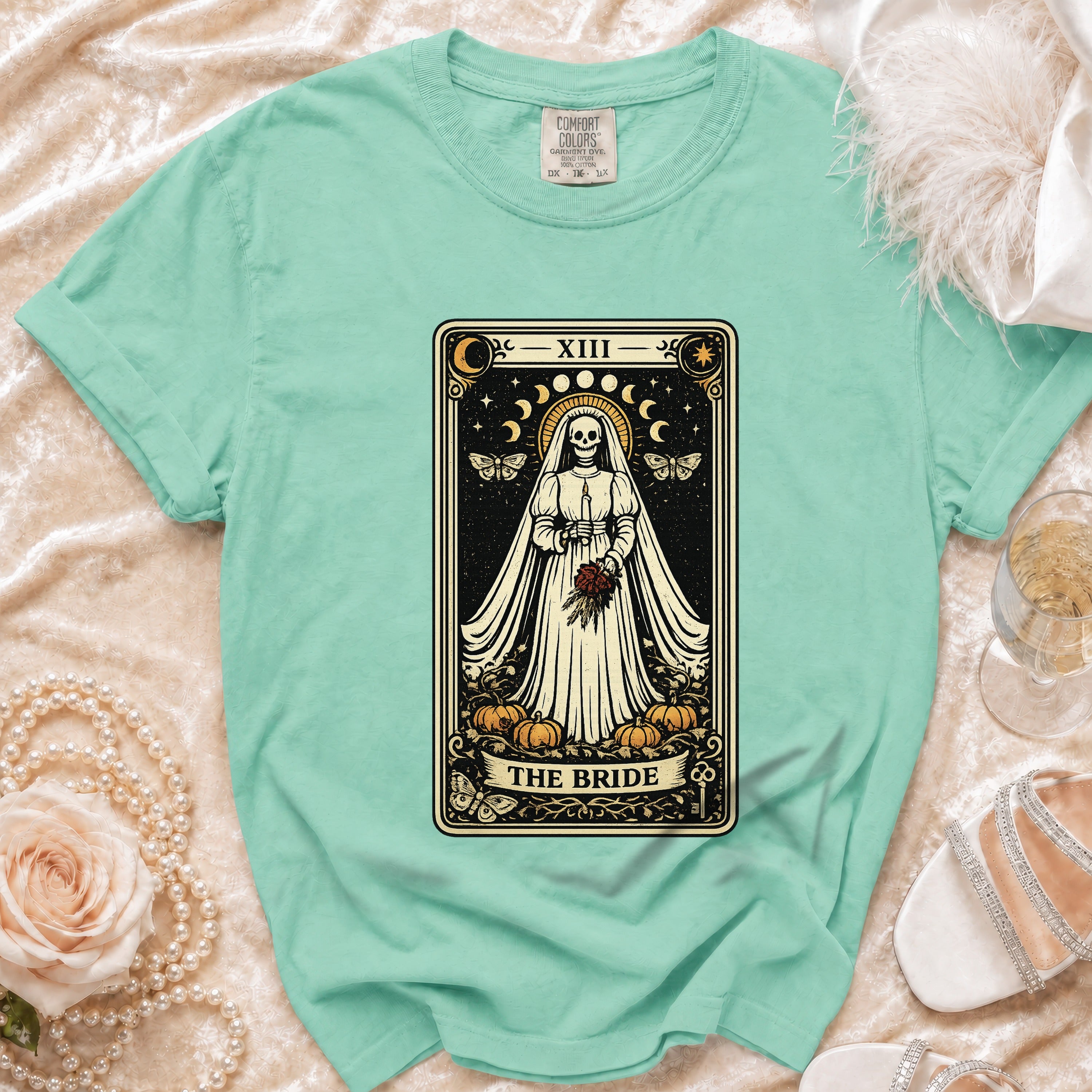 Mint green t-shirt with skeleton bride tarot card graphic and "The Bride" text.