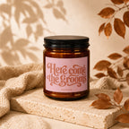 Amber jar candle with pink label reading "Here come the grooms" and "VOWED".
