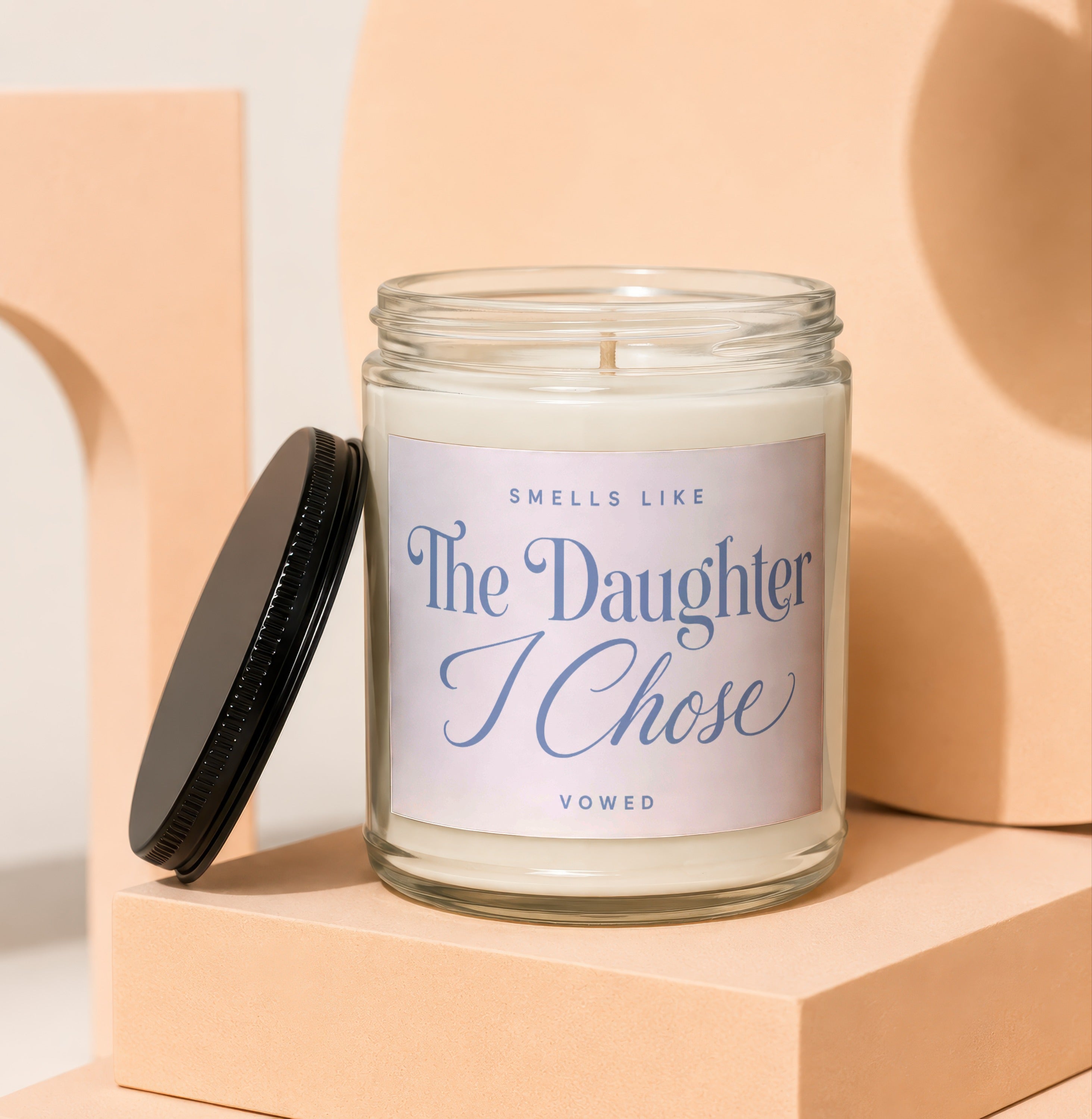 Glass jar candle reads "Smells Like The Daughter I Chose" from Vowed.
