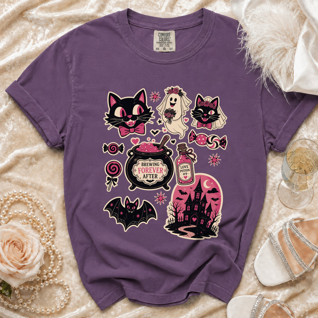 Purple t-shirt with Halloween-themed graphics including cats, a ghost bride, bat, cauldron, and haunted house.