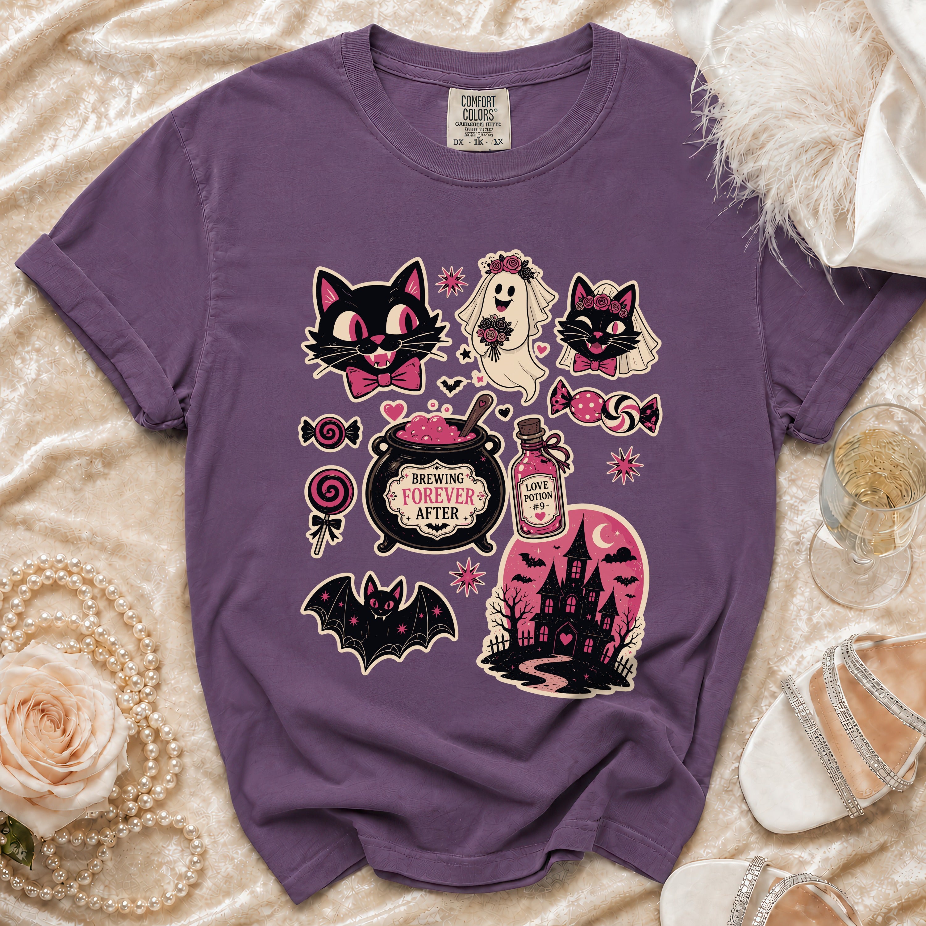 Purple t-shirt with Halloween-themed graphics including cats, a ghost bride, bat, cauldron, and haunted house.