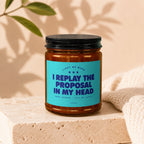 Candle with text "I replay the proposal in my head" and "Vowed".
