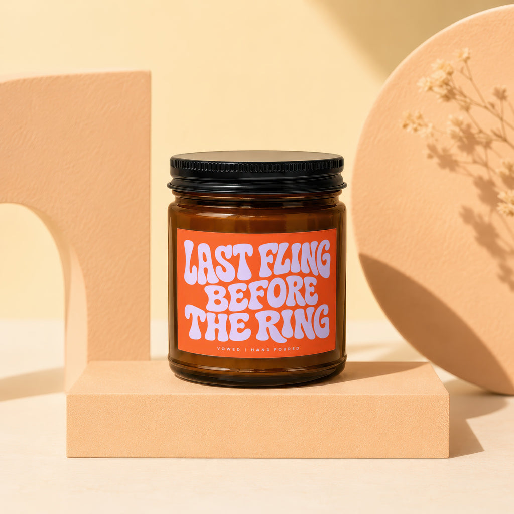 Amber candle with orange label reading "LAST FLING BEFORE THE RING".