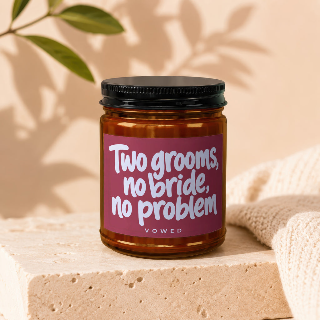 Amber jar candle with text "Two grooms, no bride, no problem VOWED".