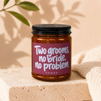 Amber jar candle with text "Two grooms, no bride, no problem VOWED".