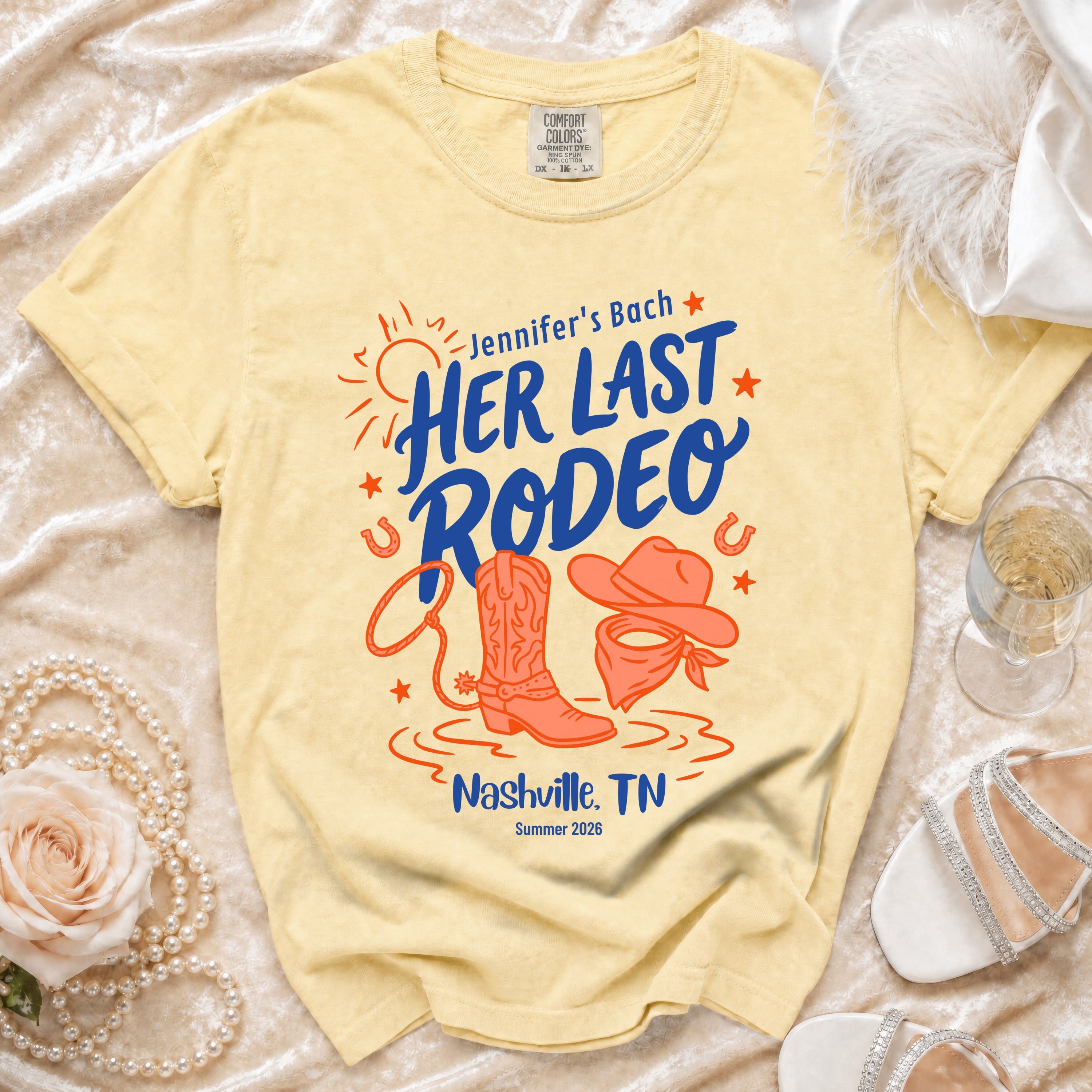 Yellow t-shirt with "Jennifer's Bach" and "Her Last Rodeo" text, boots, and bandana.