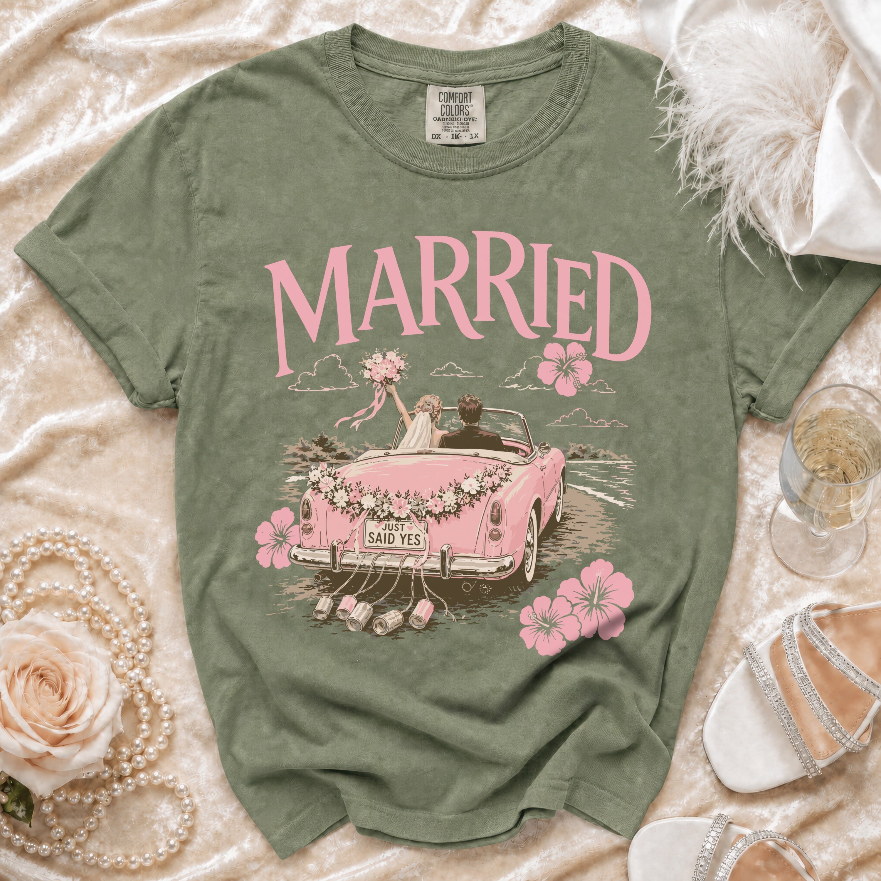 Green t-shirt with "MARRIED" and a pink graphic of a couple in a car.