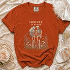 Orange t-shirt with skeleton bride and groom graphic and "Forever in Bloom" text.