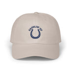 Light beige baseball cap featuring an embroidered blue horseshoe design with the text SADDLIN UP.