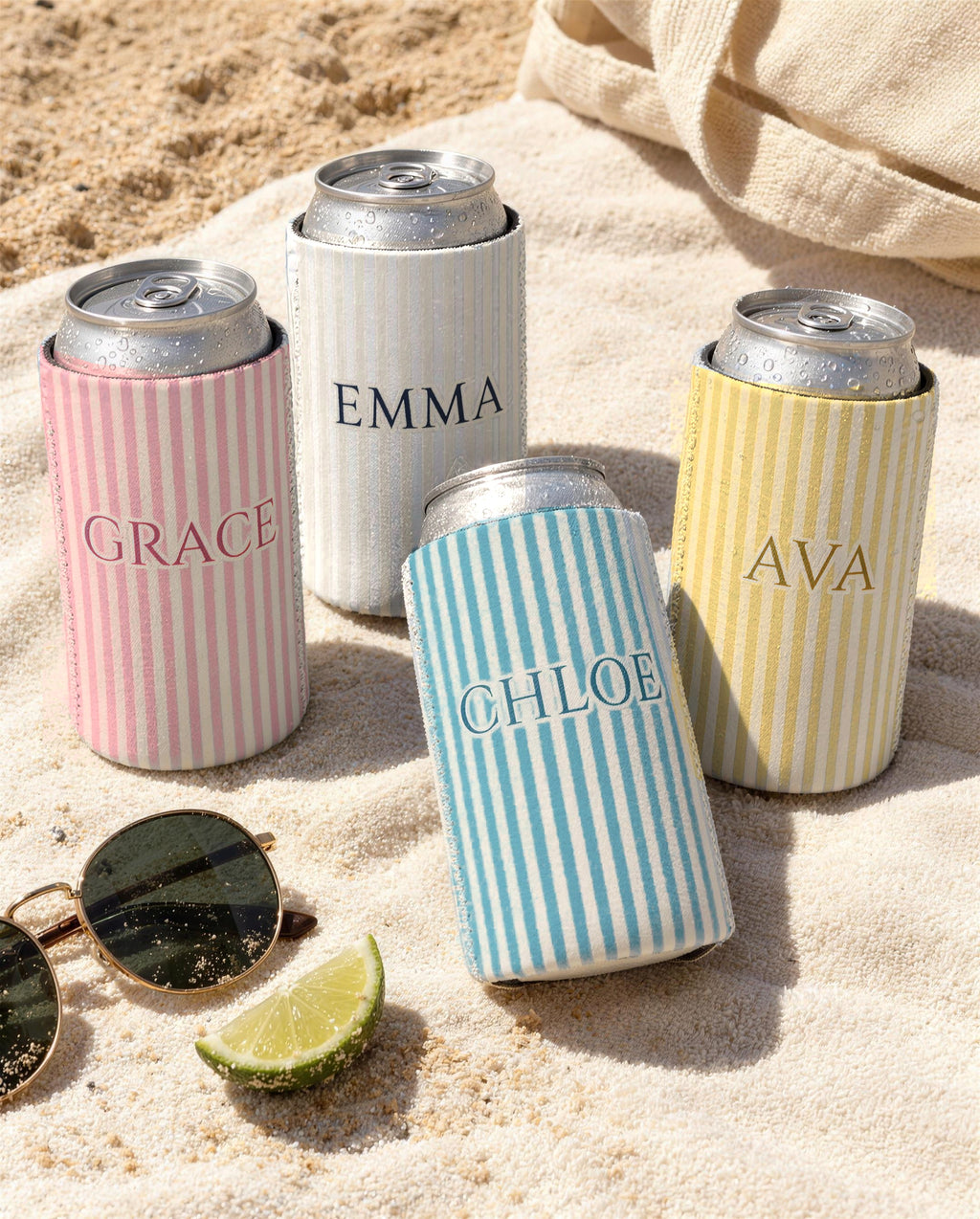 Custom name pinstripe can coolers on a beach towel: Grace in Blossom, Emma in the white Bride cooler, Chloe in Lagoon Blue, Ava in Butter