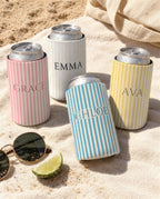 Custom name pinstripe can coolers on a beach towel: Grace in Blossom, Emma in the white Bride cooler, Chloe in Lagoon Blue, Ava in Butter
