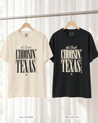 Ivory bride shirt printed in Black next to a Black crew shirt printed in ivory, Choosin' Texas tees