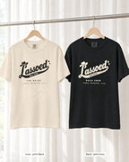 Ivory bride shirt printed in Black next to a Black crew shirt printed in ivory, Lassoed For Life tees