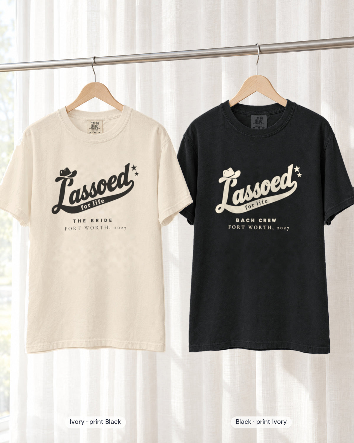 Ivory bride shirt printed in Black next to a Black crew shirt printed in ivory, Lassoed For Life tees