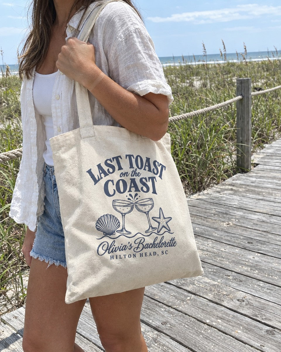 Last Toast On The Coast canvas tote carried on a beach boardwalk