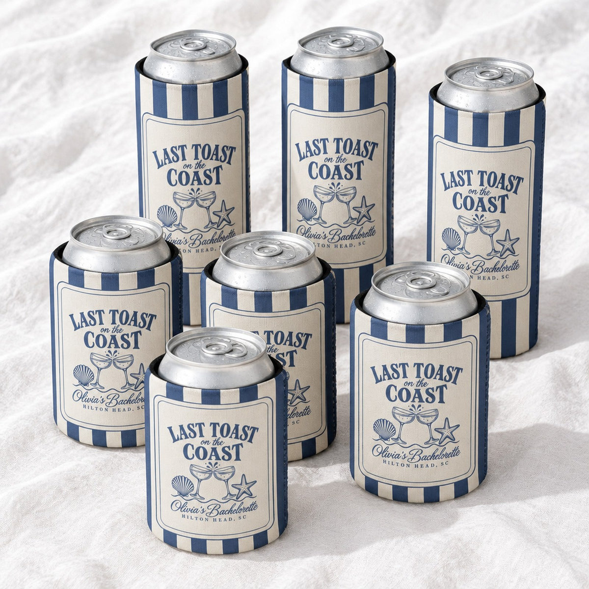 Seven striped Last Toast can coolers on linen