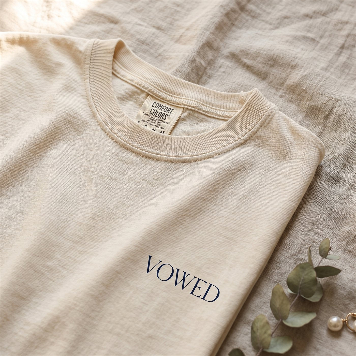 Close-up of the Comfort Colors 1717 neck label and garment-dyed cotton on a Vowed tee